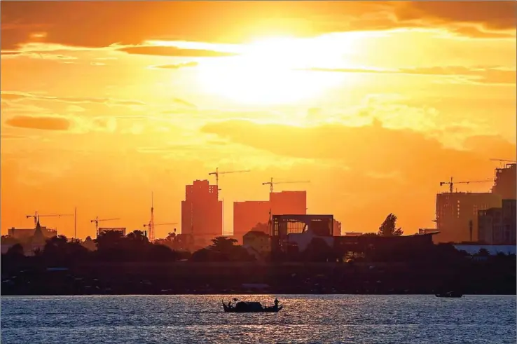  ?? TANG CHHIN SOTHY/AFP ?? A fishing boat travels along the Mekong river in Phnom Penh last week.