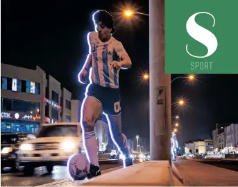  ?? | JOSE SENA GOULAO EPA ?? A huge stand-up display depicting Argentina’s Diego Armando Maradona in a street in Al Wakra, Doha, Qatar.