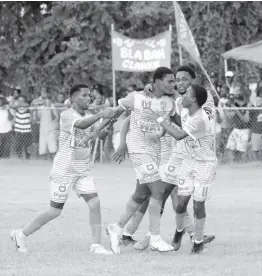  ?? PHOTO BY ASHLEY ANGUIN ?? Frome Technical High School’s Stevaughn Spence (centre) is flanked by his teammates in celebratio­n of a goal he scored during an ISSA/WATA dacosta Cup football match against Rusea’s High at the Ruseas High Sports Complex yesterday.