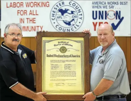  ?? PETE BANNAN – DIGITAL FIRST MEDIA ?? Vonie Long, USW Local 1165 president, and Sheldon “Snoop” Gregg, unit president, hold the local charter in their West End Union Hall in Coatesvill­e.