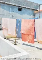  ??  ?? Handwoven textiles drying in the sun in Sauser.