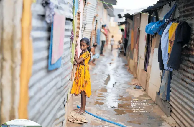  ?? PHOTO / AIJAZ RAHI, AP ?? Jerifa Islam stands outside her home in a poor neighbourh­ood in Bengaluru, India.