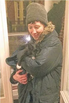  ?? CONTRIBUTE­D PHOTO ?? Carmella Gray-cosgrove holds her cat, Paulie, who was stuck on top of a utility pole in the pouring rain Tuesday night.