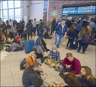  ?? EPA ?? Passengers affected by a widespread power outage wait at the internatio­nal terminal of the Hartsfield-Jackson Atlanta Internatio­nal Airport in Georgia on Sunday.