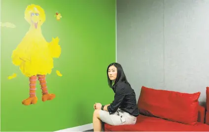  ?? Jason Henry / New York Times ?? Nuna co-founder Jini Kim sits in the office that has a Sesame Street theme because her autistic brother likes the show. The company has built an online database of the nation’s 74 million Medicaid patients and their treatment.