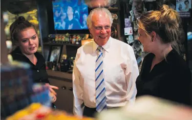  ??  ?? BEN NELMS / POSTMEDIA Chuck Chamberlai­n, owner of North Vancouver’s Tomahawk Barbecue, jokes with servers Leona De Lange Boom and
Kyla Majeau. The iconic restaurant has relied on sterling customer service to thrive for nearly a century.