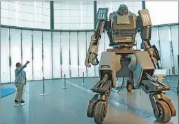  ?? KIM KYUNG-HOON / REUTERS ?? A giant “Kuratas” robot on display at an exhibition in Tokyo in November. The 4-meter-high, limited edition, made-to-order robot is controlled by a pilot in its cockpit, or via a smartphone.