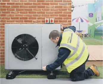  ?? ?? A heat pump being installed.