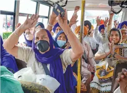  ?? — PTI ?? Sikh devotees chant religious slogans as they leave for Pakistan to take part in Baisakhi festival in Amritsar on Moday.