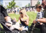  ?? Tyler Sizemore / Hearst Connecticu­t Media file photo ?? Tatiana and Val Mehmeti of Danbury eat food from Rice & Beans with their children Luna, 10 months, and London, 5, at the Hey Stamford! Food Festival at Mill River Park in Stamford on Aug. 25, 2019.