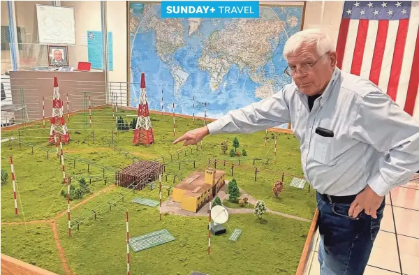  ?? PHOTOS BY STEVE STEPHENS/SPECIAL TO THE DISPATCH ?? John Dominic, executive director of the Voice of America Museum, explains a scale model of the Bethany Station site.