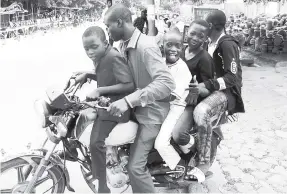  ??  ?? Five the hard way! Boys have fun on a motorcyle in Ougadougou, which Peter Espeut refers to as ‘motorbike city’.