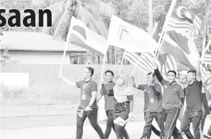  ??  ?? KUMPULAN pelajar Kolej Komuniti memulakan perarakan membawa bendera sempena Kempen Kibarkan Jalur Gemilang.