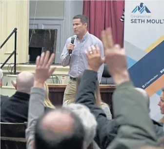  ?? JIM MICHAUD PHOTOS / BOSTON HERALD ?? INDOOR HEAT: Bay State U.S. Rep. Seth Moulton takes questions yesterday in Amesbury about his opposition to Nancy Pelosi for House speaker. Some in the crowd brought signs to show their support of Pelosi.