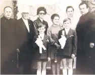  ?? COURTSY OF JANUSZ KOWALSKI ?? Janusz Kowalski, boy on left, and brother Jozef on their day of communion. Their father, Rev. Boleslaw Petlicki, is on the far left; their mother, Regina, is second from the right.