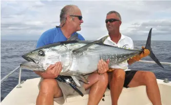  ??  ?? The author (on left) with a bluefin tuna caught in the Mediterran­ean Sea. Tuna stocks there have steadily increased over the past decade.