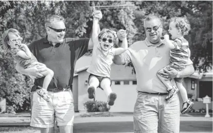  ?? PHOTOS BY MARK HENLE/THE REPUBLIC ?? Kelsie Bell, Aaron Bell, Caitlin Bell, Sid Cuecha and Riley Bell take a morning walk in their north Phoenix neighborho­od. Starting a family through surrogacy was “the best thing that we’ve done our entire lives,” Aaron Bell said.