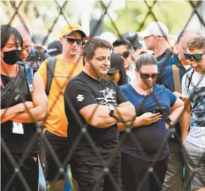  ??  ?? Fans wait outside the gates of the F1 Australian Grand Prix circuit in Albert Park, Melbourne, last Friday before the race was officially called off.