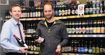  ??  ?? Dermot Hartigan, Manager serving customer Jurgen Bastiaanse­n in the Off Licence Dept at Murphy’s SuperValu, Kenmare.