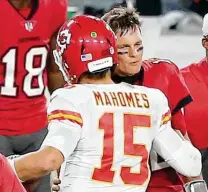  ?? Cliff Welch / Getty Images ?? The Super Bowl quarterbac­k duel between Tom Brady and Patrick Mahomes, chatting after the Chiefs beat the Buccaneers 27-24 on Nov. 29, represents a perfect ending for the NFL.