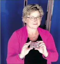  ?? CP PHOTO ?? Crystal Regehr Westergard holds a Cuban Lunch, a rectangula­r peanutand-chocolate confection, in this undated handout photo. Every time Crystal Regehr Westergard would go out shopping as a youth, she would ask her mother if she wanted anything. There...