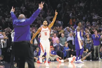  ?? Michael Perez / Associated Press ?? Houston’s Eric Gordon (10) floors teammate James Harden and also floors the 76ers with a three-pointer at the buzzer. Gordon scored 29 points and Harden 27 in the Rockets’ victory.