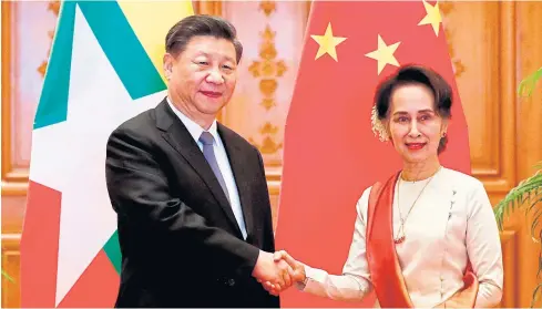  ??  ?? FRIENDS FOREVER: Chinese President Xi Jinping, left, and Myanmar State Counsellor Aung San Suu Kyi shake hands after signing a memorandum of understand­ing at the presidenti­al palace in Nay Pyi Taw yesterday.