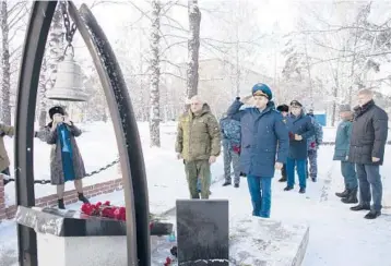 ?? SERGEI GAVRILENKO/AP ?? Kemerovo Governor Sergei Tsivilyov, center left, and Russian Deputy Prosecutor General Dmitrii Demeshin, center, lay flowers Friday at the memorial to honor fallen rescuers in Gramoteino village in Russia. Rescue crews found a survivor in a Siberian coal mine where dozens of miners are presumed dead after an explosion, a senior regional official said Friday.