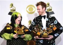  ??  ?? US singer-songwriter Billie Eilish (left) and Finneas O’Connell pose in the press room with the awards for Album Of The Year, Record Of The Year, Best New Artist, Song Of The Year and Best Pop Vocal Album during the 62nd Annual Grammy Awards.