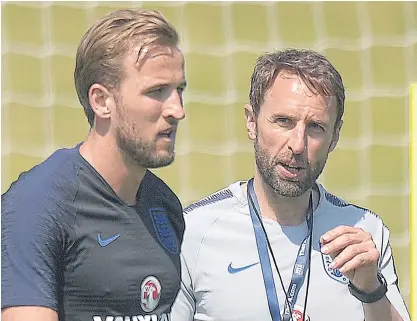  ??  ?? England manager Gareth Southgate, right, talks with striker Harry Kane during a training session.