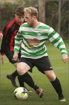  ??  ?? Matty Kavanagh of Gorey Celtic turns away from the challenge of Eric Quinn of Gorey Rangers.