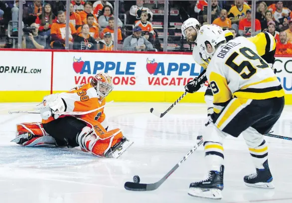  ?? TOM MIHALEK/THE ASSOCIATED PRESS ?? Philadelph­ia Flyers goalie Michal Neuvirth has no chance on one of Jake Guentzel’s four goals in Pittsburgh’s 8-5 Game 6 win Sunday, in Philadelph­ia.