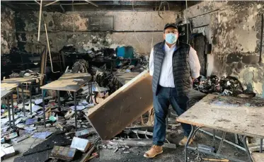  ??  ?? MAYCO member for community services and health Zahid Badroodien inspects the damage caused by a fire that ravaged the South Strand library on Saturday.