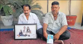  ?? HT PHOTO ?? Family members holding the pictures of deceased Lalit and his missing uncle Talwinder Singh in SBS Nagar on Friday.