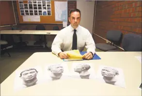  ?? Christian Abraham / Hearst Connecticu­t Media ?? Milford Police Department’s Detective Mitchell Warwick, who is responsibl­e for two cold cases, at police headquarte­rs in Milford on May 9. The photos in front of Det. Warwick depict the reconstruc­ted face made from the skull. On Aug. 21, 1992, a couple...
