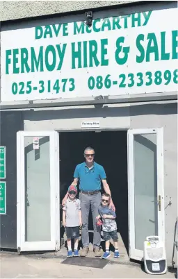  ?? ?? BEST OF LUCK DAVE - Dave McCarthy, Fermoy Hire & Sales, being congratula­ted by his grandsons Luke and Jake on his retirement.