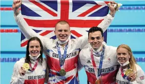  ?? JOE GIDDENS/PA ?? OLYMPIC CHAMPIONS: GB’s mixed 4x100m medley relay team, from left, Kathleen Dawson, Adam Peaty, James Guy and Anna Hopkin