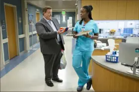  ?? Sonja Flemming/ CBS ?? Billy Cardell and Folake Olowofoyek­u star in “Bob [ Hearts] Abishola,” in which a middle- aged sock businessma­n from Detroit, after having a heart attack, falls for his cardiac nurse, a Nigerian immigrant.