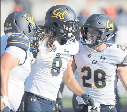  ?? AMANDA LOMAN — THE ASSOCIATED PRESS ?? Cal’s Ryan Gibson, left, and Patrick Laird (28) congratula­te wide receiver Kanawai Noa (9) after Noa scored a touchdown on a pass during the Bears’ 49-7 win at Oregon State on Saturday. It was Cal’s first Pac-12 Conference victory of the season.