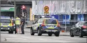  ?? AP/JOHAN NILSSON ?? Police cordon off an area in central Malmo, Sweden, on Monday. A Swedish newspaper is reporting that four people were injured in a shooting near a police station in the southern city of Malmo. Witnesses told newspaper Aftonblade­t they heard what...