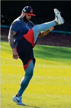  ?? CURTIS COMPTON / CCOMPTON@AJC.COM ?? Braves left-hander Luiz Gohara gets in some leg kicks while loosening up on the field as pitchers and catchers reported for the first day of spring training Friday in Lake Buena Vista, Fla.