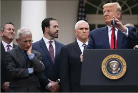  ?? EVAN VUCCI—ASSOCIATED PRESS ?? Dr. Anthony Fauci, director of the National Institute of Allergy and Infectious Diseases, listens as President Donald Trump speaks during a news conference on the coronaviru­s in the Rose Garden at the White House, Friday, March 13, 2020, in Washington.