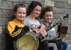  ??  ?? Listowel musicians Lauryn Griffin, Aisling Joy and Aoife Griffin taking part in the on-street entertainm­ent at Fleadh Cheoil na Mumhan in their home town.