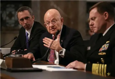  ?? GETTY IMAGES PHOTOS ?? RIGHT TO REMAIN SILENT: Former Director of National Intelligen­ce James Clapper, center, testifies before the Senate Armed Services Committee in 2017.