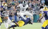  ?? CHARLES REX ARBOGAST/ASSOCIATED PRESS ?? Michigan State running back LJ Scott put together a career-best season despite the team’s offensive woes.