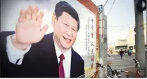  ?? PICTURE: AP ?? People walk past a billboard, showing Chinese President Xi Jinping, in Beijing, on Friday. The annual meeting of China’s top legislativ­e bodies began at the weekend with draft amendments to the constituti­on about the two-term limit on China’s...