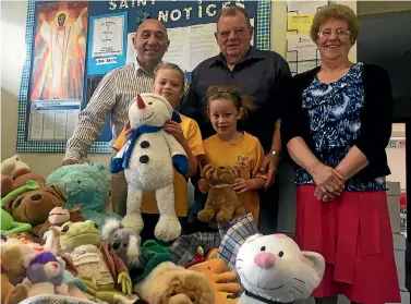  ?? PHOTO: JACK BARLOW/FAIRFAX NZ ?? Wairarapa MP Ron Mark, left, joins David and Carol Mullany to pack the hundreds of soft toys donated to comfort shaken Kaikoura children. Among those who offered their beloved toys were, from left: Maiah Purcell and Emily Mullany.