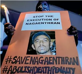  ?? AP ?? Protesters hold posters against the impending execution of Nagaenthra­n K Dharmaling­am, sentenced to death for traffickin­g heroin into Singapore, on Tuesday outside the Singaporea­n embassy in Kuala Lumpur. He was executed on Wednesday.