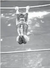  ?? [PHOTOS BY SARAH PHIPPS/ THE OKLAHOMAN] ?? OU's Anastasia Webb performs on the uneven bars Sunday at Lloyd Noble Center in Norman.