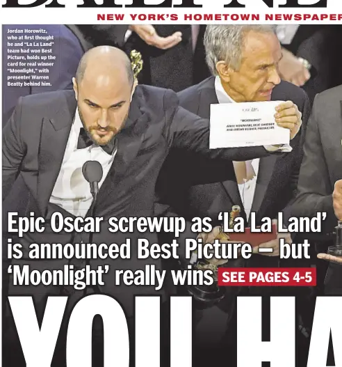  ??  ?? Jordan Horowitz, who at first thought he and “La La Land” team had won Best Picture, holds up the card for real winner “Moonlight,” with presenter Warren Beatty behind him.